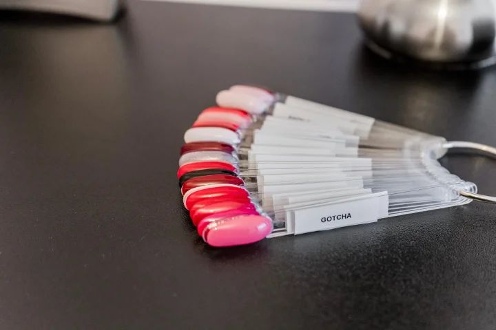 Kleurstalen in roodroze op de nageltafel
